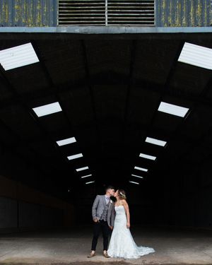 bride and groom kissing under lights