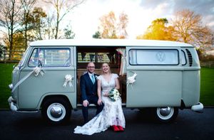 Bride & Groom sitting on the side of a VW camper van